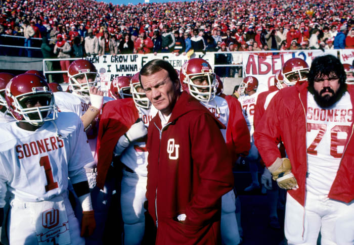 Oklahoma Sooners head coach Barry Switzer leads his team on the field against the Nebraska Cornhuskers at Memorial Stadium.
